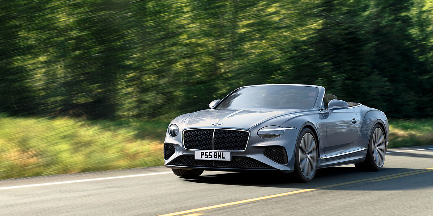 Bentley San Juan New Bentley Continental GTC convertible front view in Silverlake paint with 22 inch ten spoke wheels, driving dynamically on a country road