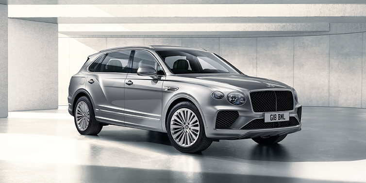 Bentley San Juan Bentley Bentayga Extended Wheelbase SUV front three quarter in Moonbeam paint with a grey background