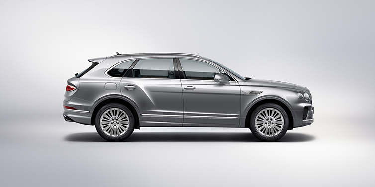 Bentley San Juan Bentley Bentayga SUV side profile in Moonbeam silver paint against white background featuring 21 inch 5 spoke wheels